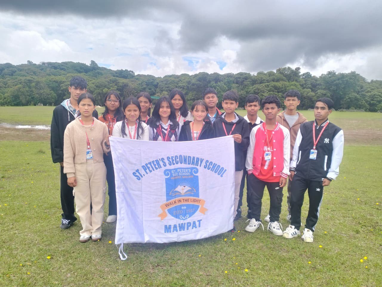 Students holding official school banner