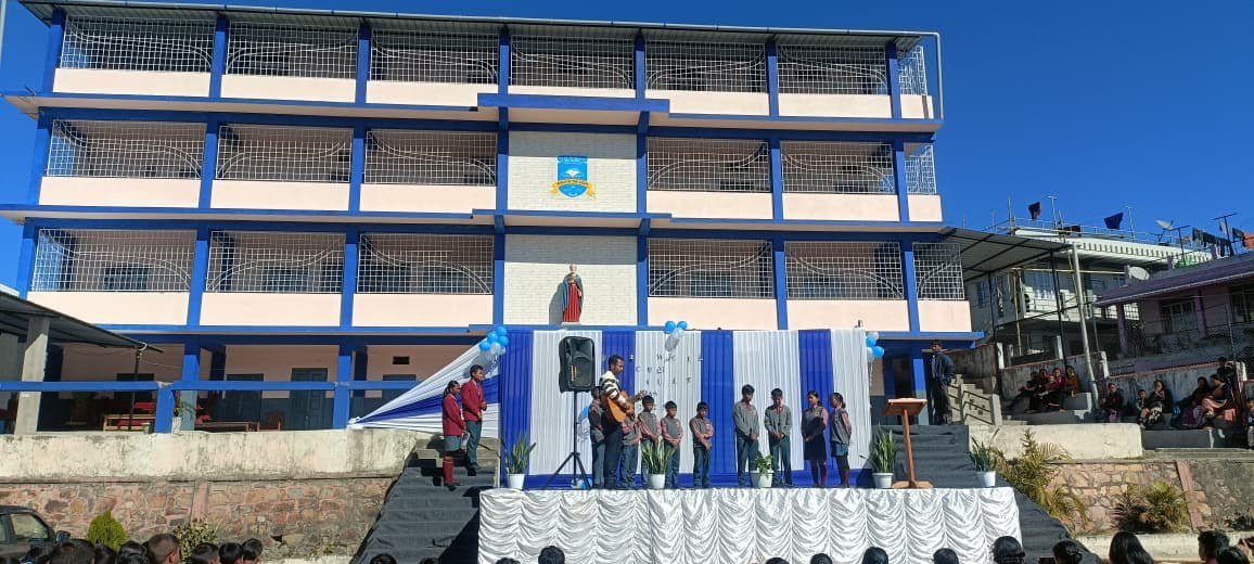 School campus building and courtyard stage